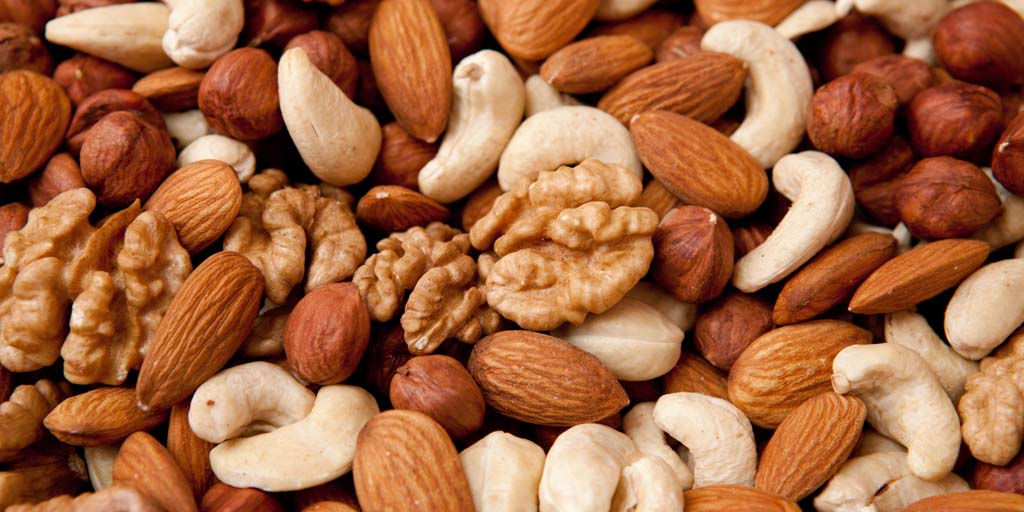 Assorted nuts (almonds, filberts, walnuts, cashews), close-up; Shutterstock ID 69739621; PO: aol; Job: production; Client: drone
